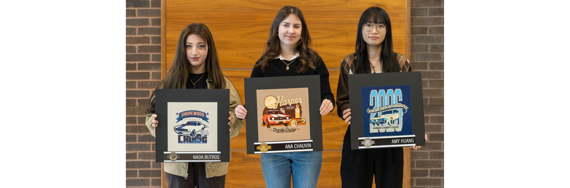 Macomb Community College students pose with their winning designs in the 2026 Shorewood Kiwanis Charity Cruise logo contest. (From left to right) Nada Butros, of Warren, third place; Ana Chauvin, of Clinton Township, first place; and Amy Huang, of Clinton Township, second place. 